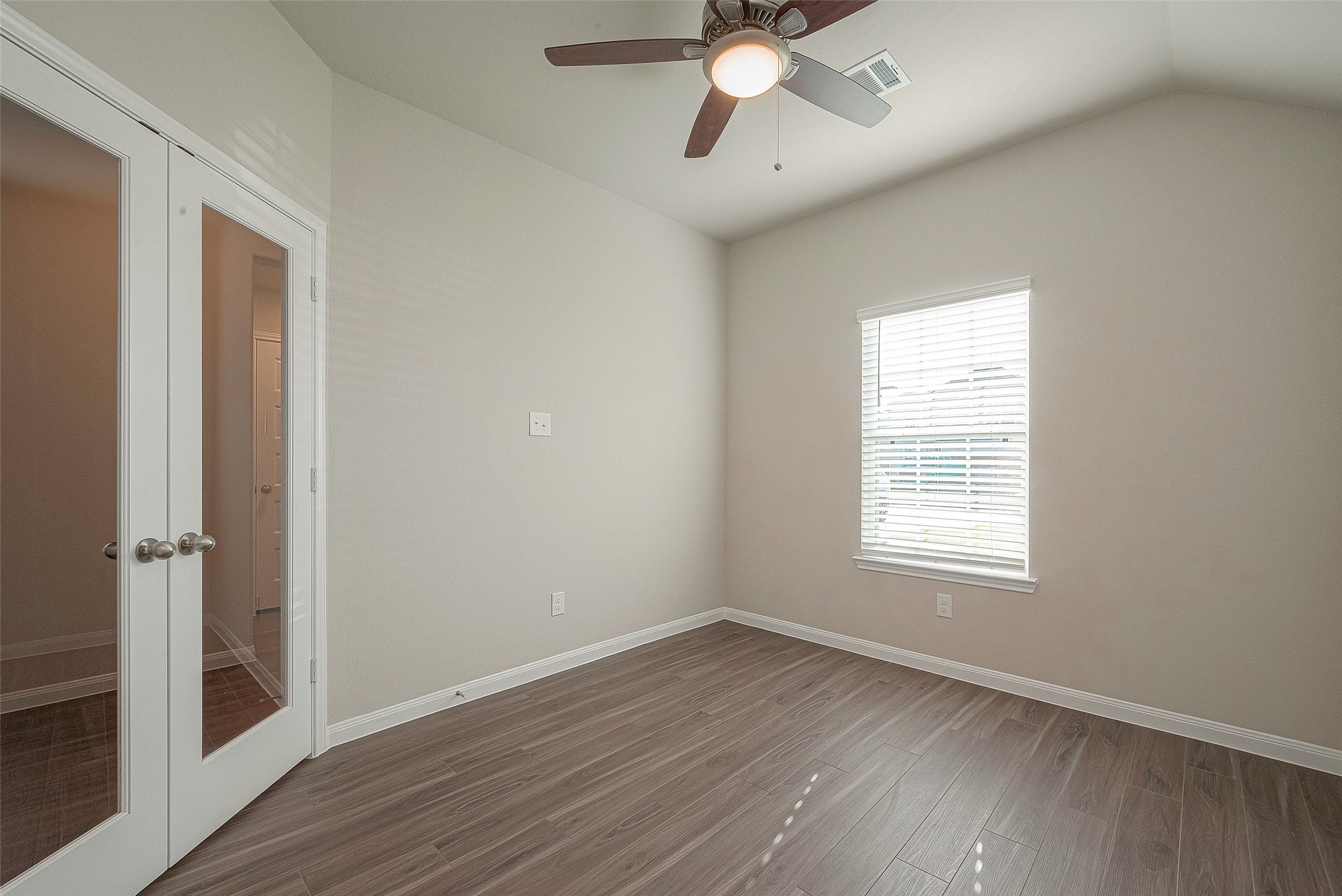 5318 Briana Dee Drive Rosharon, TX 77583 - Photo 7 of 29 an empty room with wooden floor fan and windows