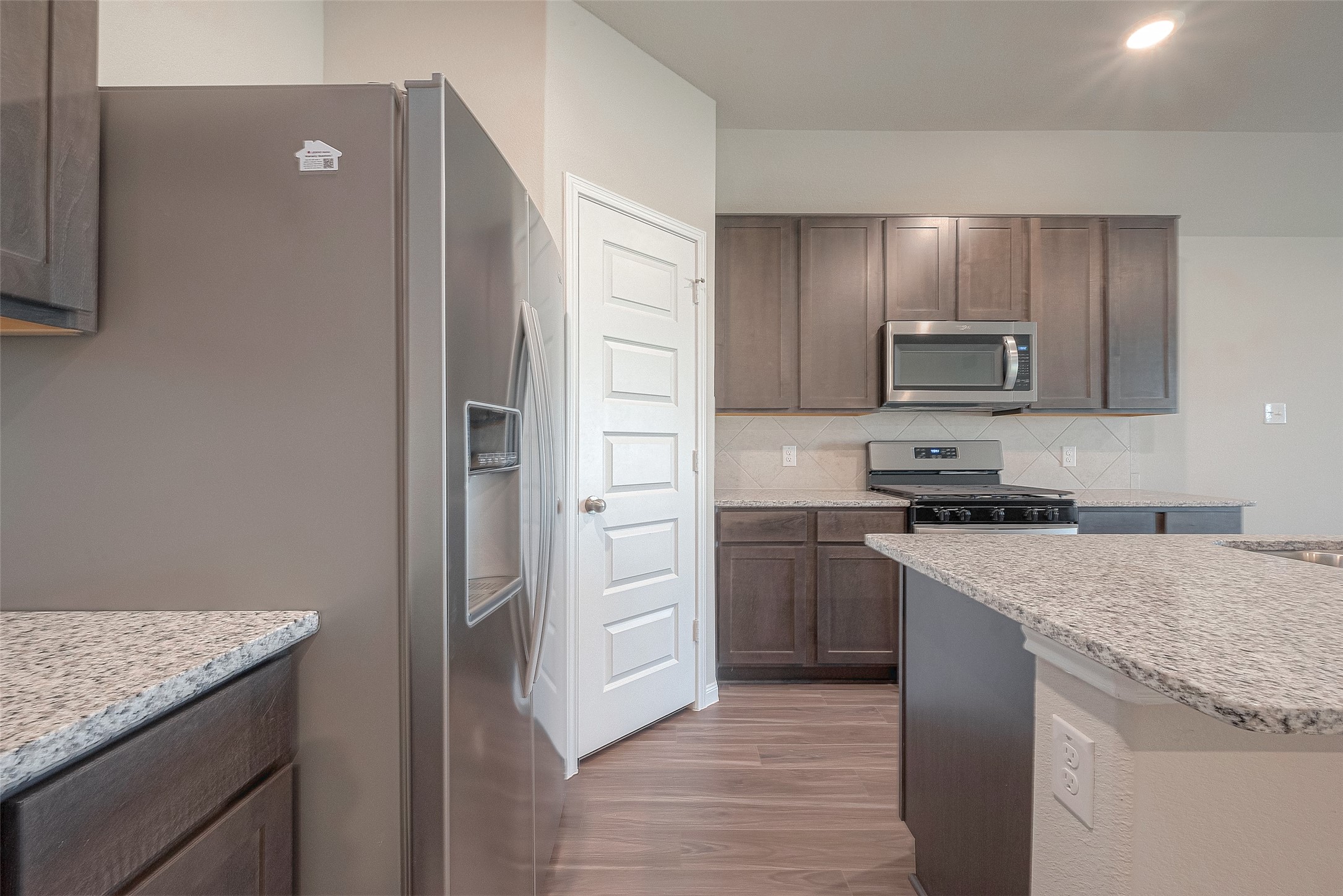 5318 Briana Dee Drive Rosharon, TX 77583 - Photo 10 of 29 a kitchen with stainless steel appliances granite countertop a refrigerator and a stove top oven