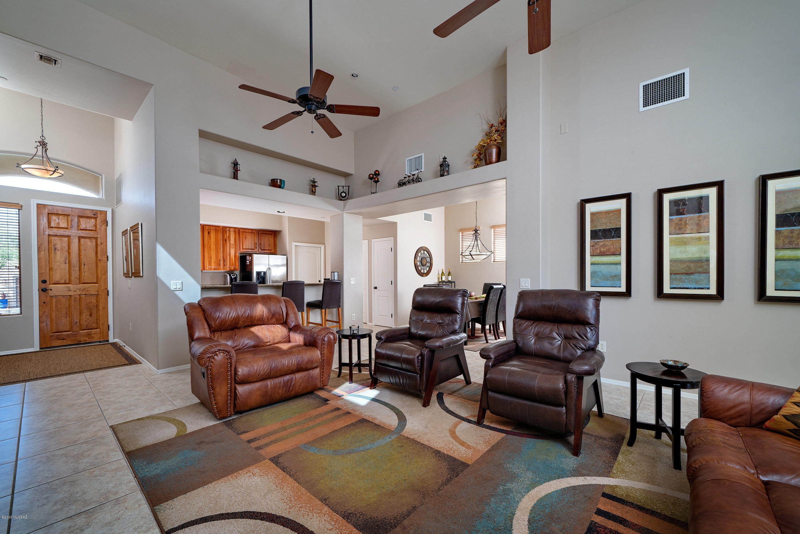 4440 West Crystal Ranch Place Marana, AZ 85658 - Photo 28 of 28 a living room with furniture ceiling fan and a rug