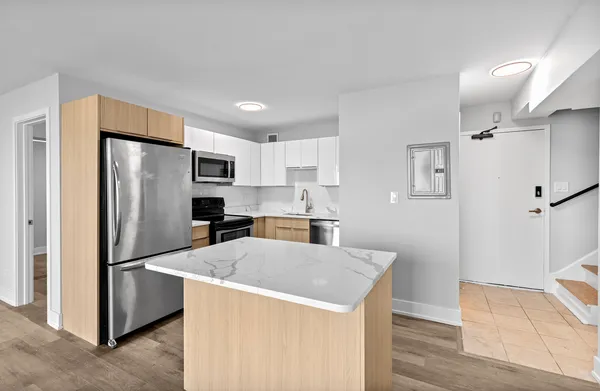 a kitchen with stainless steel appliances a refrigerator and a stove top oven