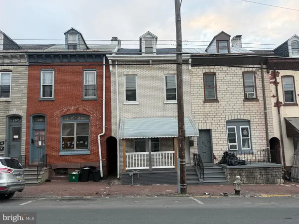 a front view of a house with a parking area