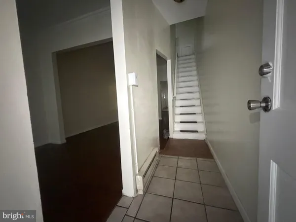 a view of a livingroom with wooden floor and a window