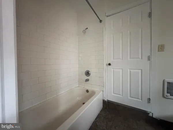 a view of a hallway with white walls