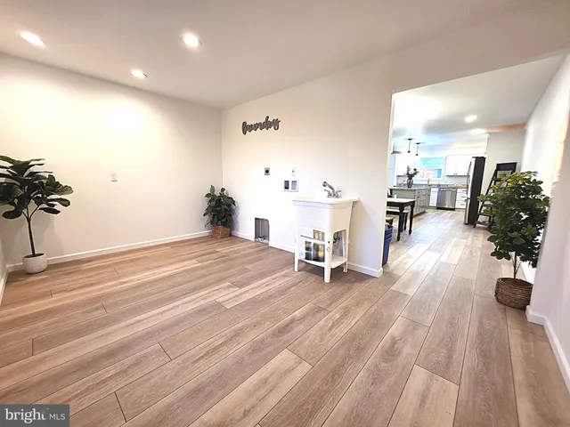 an empty room with wooden floor and furniture