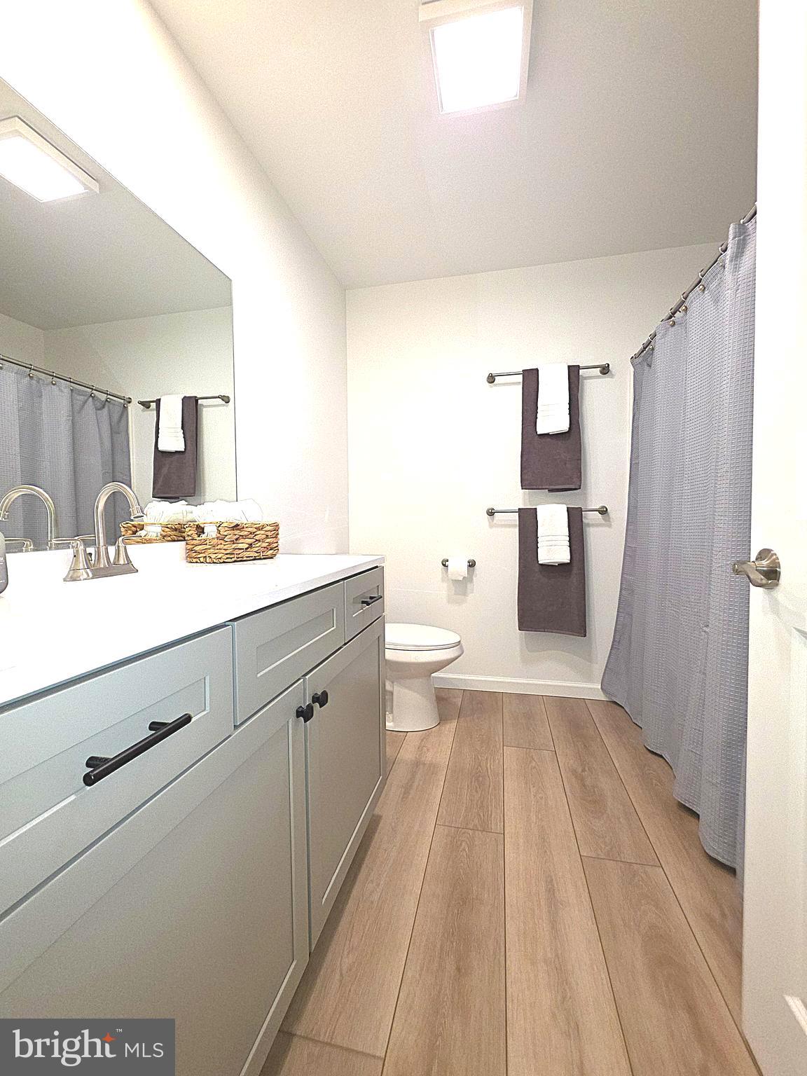 108 Bungalow Road Enola, PA 17025 - Photo 18 of 23 a spacious bathroom with a sink a toilet a mirror and shower