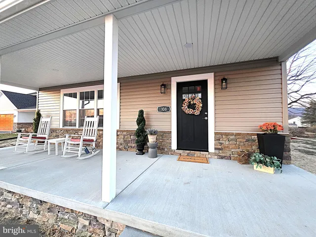 a view of a patio with table and chairs and potted plants