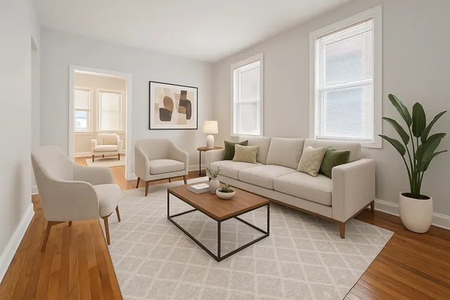 a living room with furniture potted plant and window