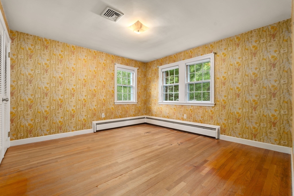 209 Bristol Road Wellesley, MA 02481 - Photo 18 of 29 a view of an empty room with a window and wooden floor