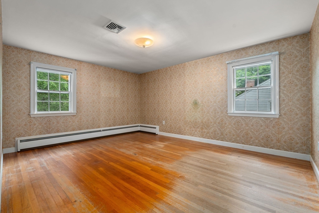 209 Bristol Road Wellesley, MA 02481 - Photo 24 of 29 a view of an empty room with wooden floor and a window