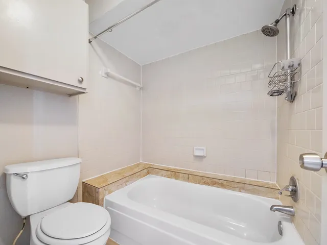a bathroom with a granite countertop sink a mirror and a shower