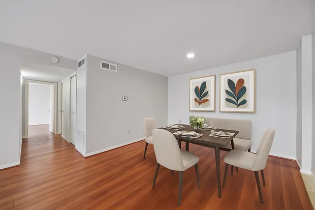 a view of a dining room with furniture and wooden floor