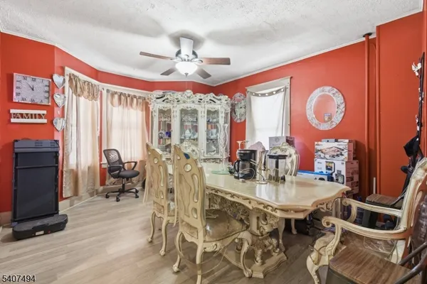 a view of a livingroom with wooden floor and stairs