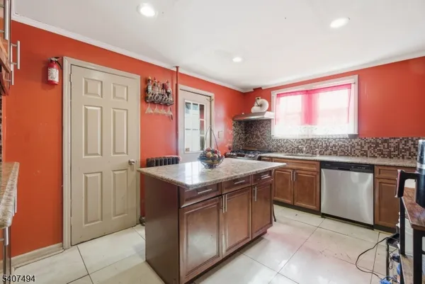 a living room with furniture a flat screen tv and a floor to ceiling window