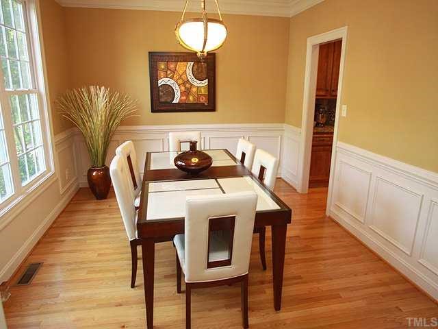9108 Wellsley Way Raleigh, NC 27613 - Photo 3 of 14 a view of a dining room with furniture and wooden floor