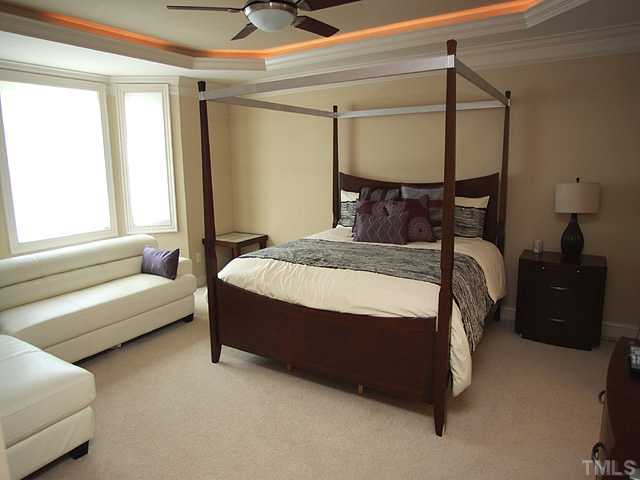 9108 Wellsley Way Raleigh, NC 27613 - Photo 5 of 14 a bedroom with a bed and a couch