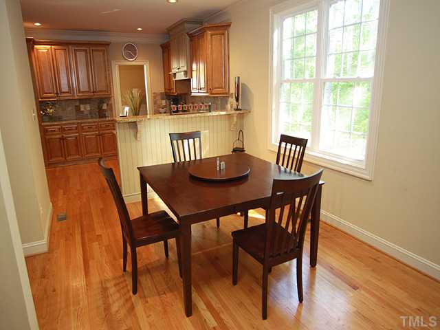9108 Wellsley Way Raleigh, NC 27613 - Photo 6 of 14 a view of a dining room with furniture and wooden floor