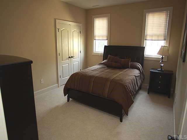 9108 Wellsley Way Raleigh, NC 27613 - Photo 9 of 14 a bedroom with a bed and window