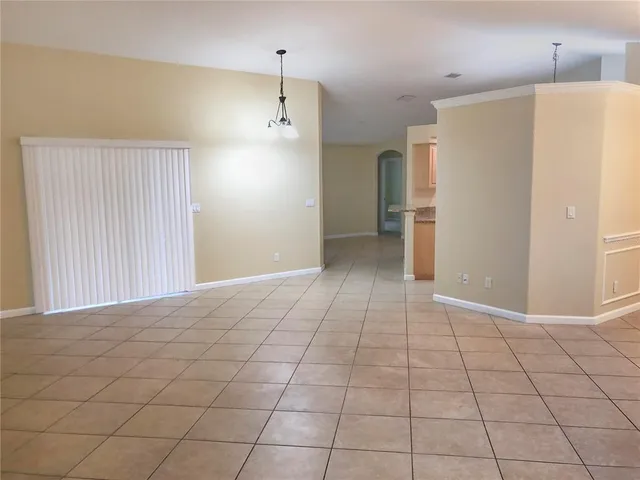 a view of an empty room with a kitchen