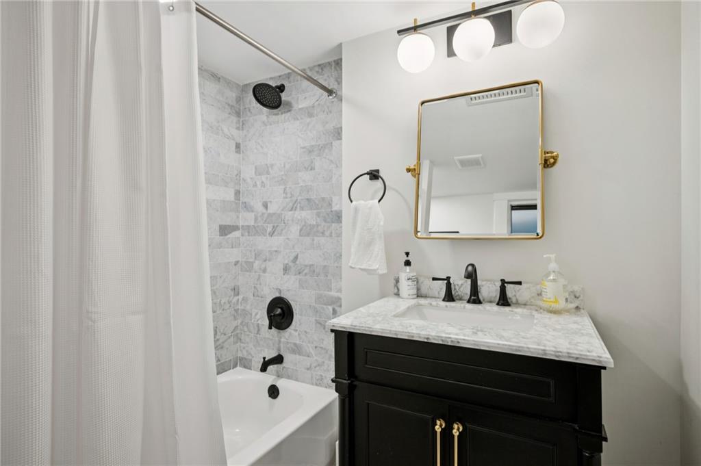 926 Waverly Way Northeast, Unit F Atlanta, GA 30307 - Photo 19 of 33 a bathroom with a sink and a mirror