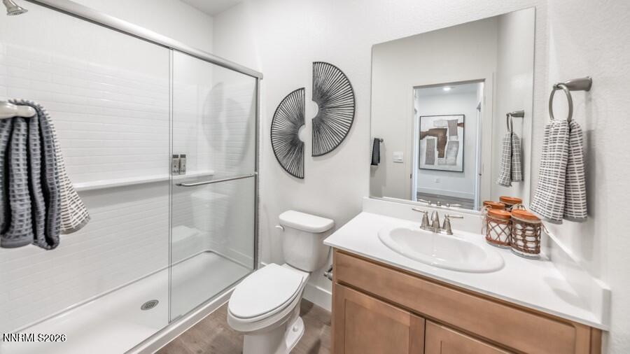 4302 Painted Cloud Way Sparks, NV 89436 - Photo 26 of 30 a bathroom with a granite countertop sink a toilet and a mirror