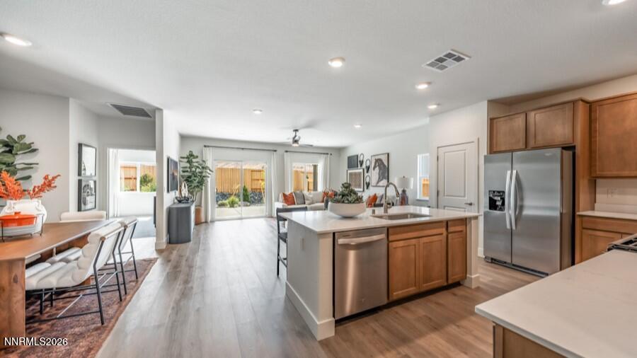 4302 Painted Cloud Way Sparks, NV 89436 - Photo 5 of 30 a kitchen with stainless steel appliances granite countertop a lot of counter space and wooden floors