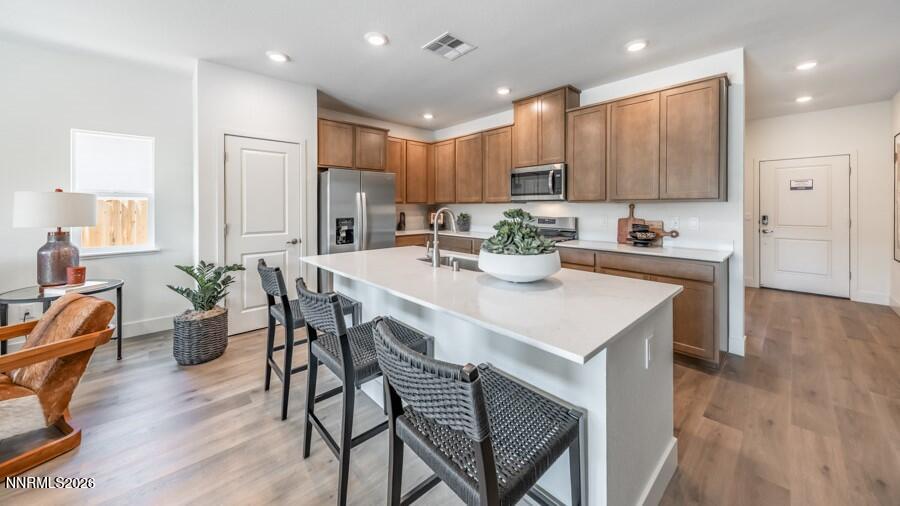 4302 Painted Cloud Way Sparks, NV 89436 - Photo 6 of 30 a kitchen with a dining table chairs and refrigerator