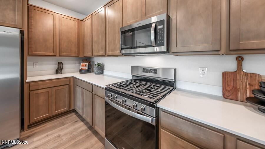 4302 Painted Cloud Way Sparks, NV 89436 - Photo 8 of 30 a kitchen with stainless steel appliances granite countertop a sink stove and microwave