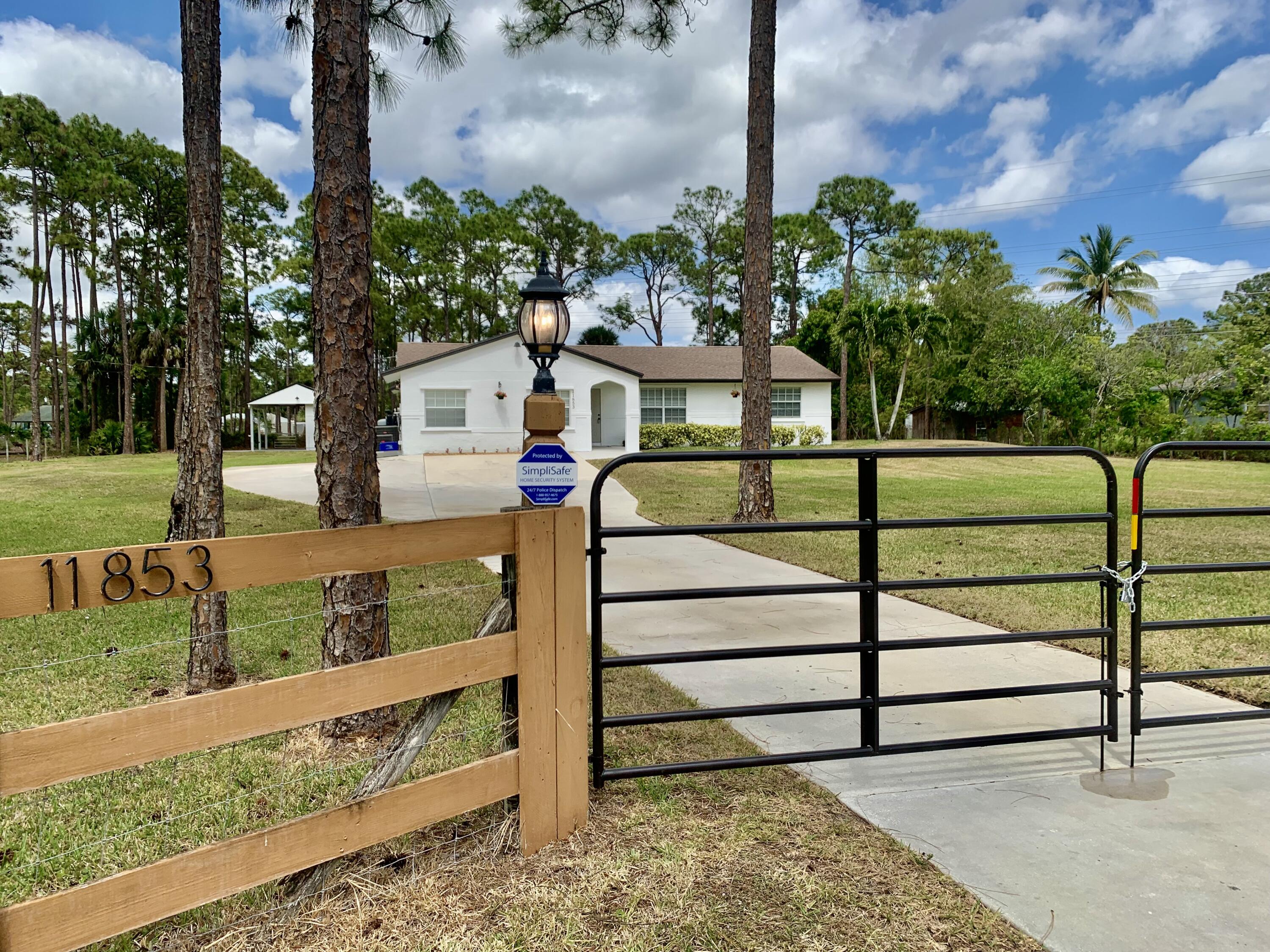 11853 47th Road North The Acreage, FL 33411 - Photo 2 of 22 Front Gate 59
