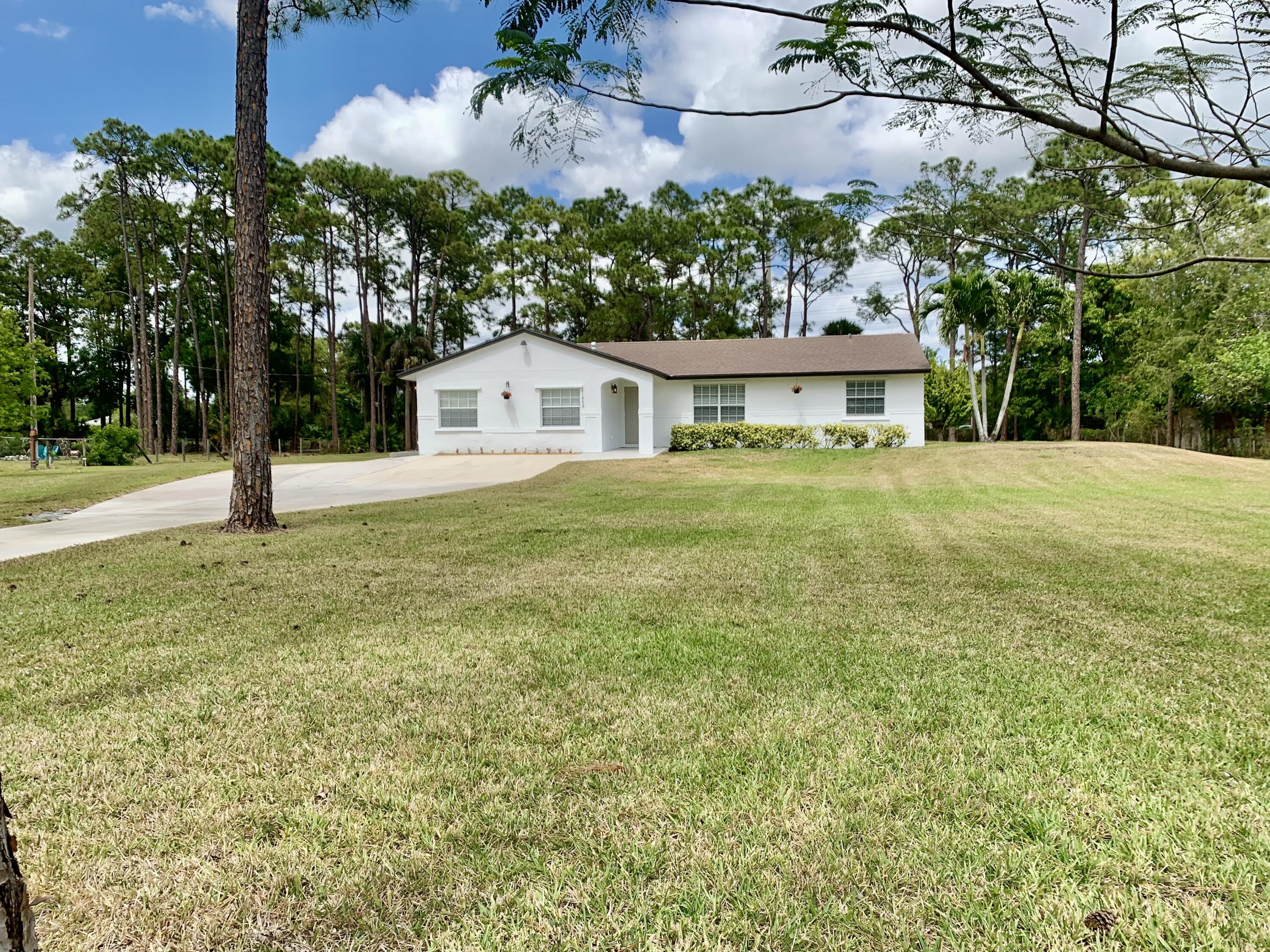 11853 47th Road North The Acreage, FL 33411 - Photo 3 of 22 Front Yard 57