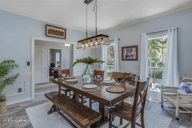 a dining room with furniture a rug and a chandelier