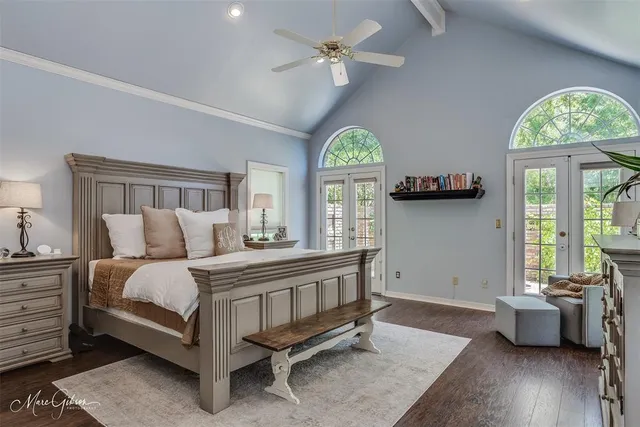 a spacious bedroom with a bed and a chandelier