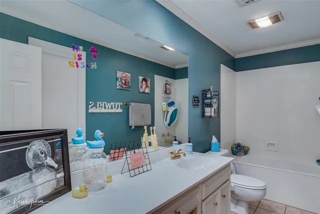 a bathroom with a sink mirror vanity and toilet