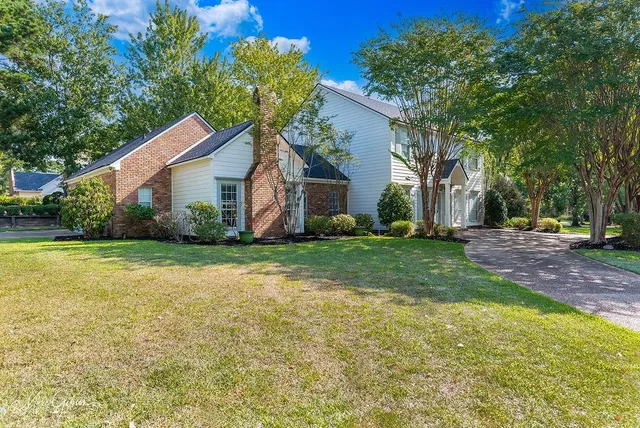 a front view of house with yard and green space