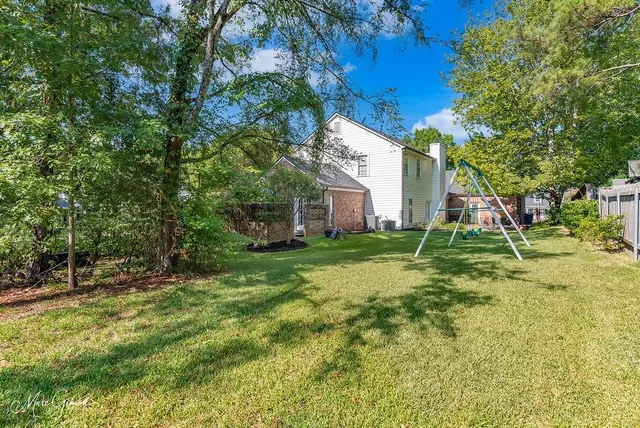 a view of a house with a backyard