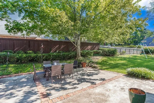 a view of a chairs and table in backyard