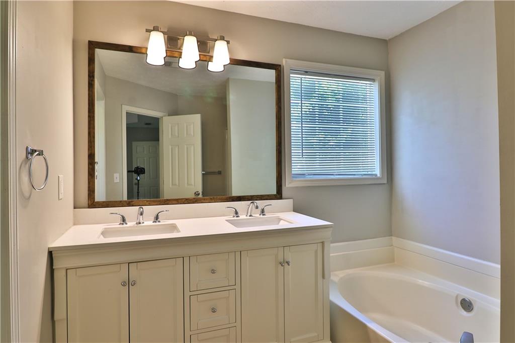 353 Fall View Court Winder, GA 30680 - Photo 39 of 61 a bathroom with a sink tub double vanity and a mirror