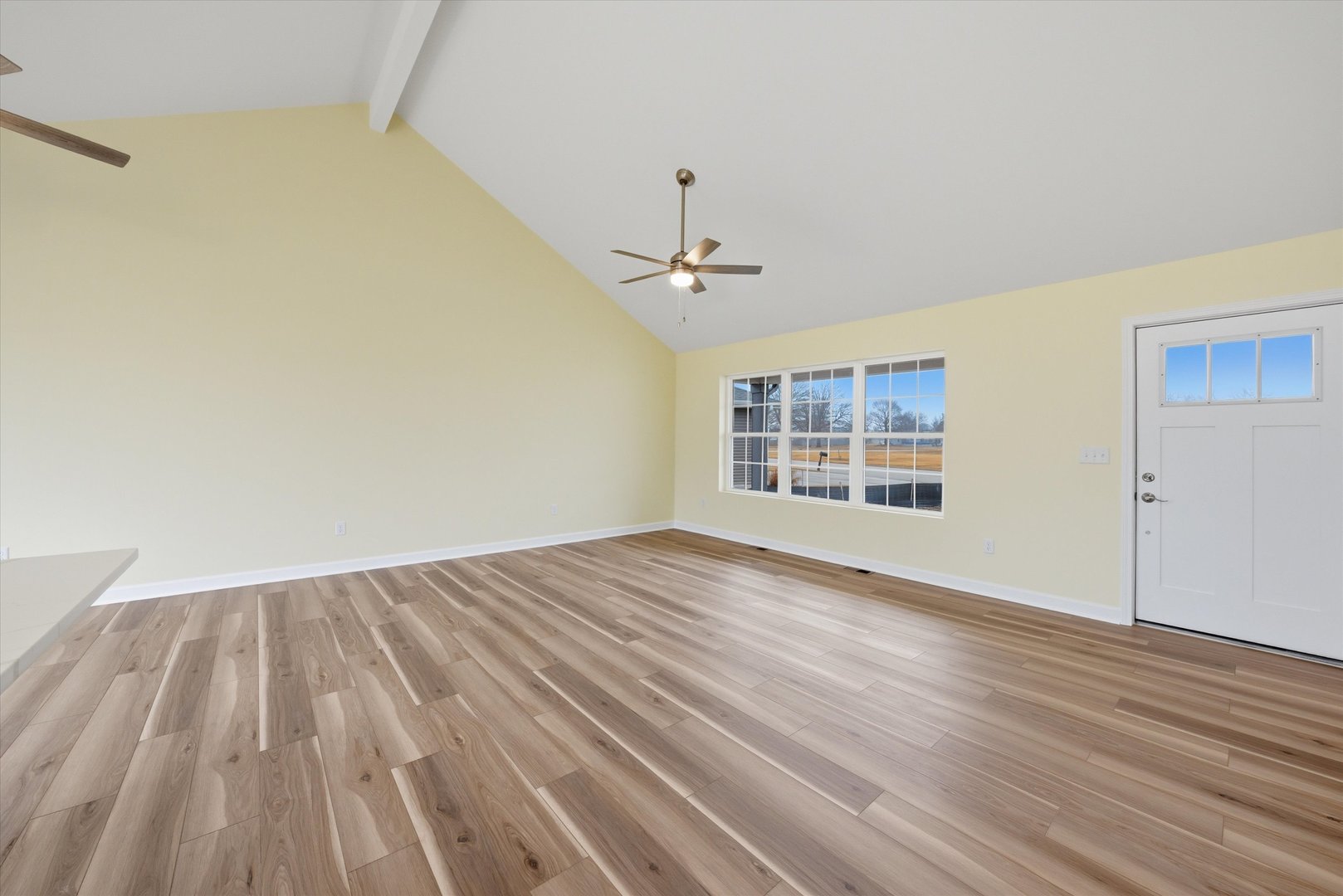 477 Emma Drive Manteno, IL 60950 - Photo 4 of 29 a view of an empty room with wooden floor and a window