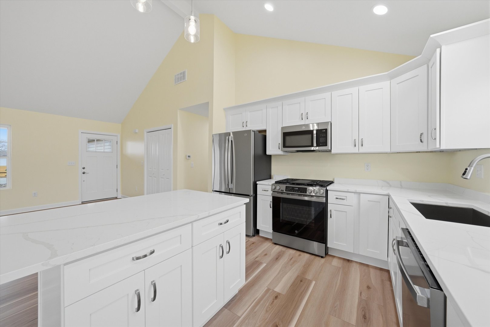 477 Emma Drive Manteno, IL 60950 - Photo 7 of 29 a kitchen with granite countertop white cabinets and stainless steel appliances