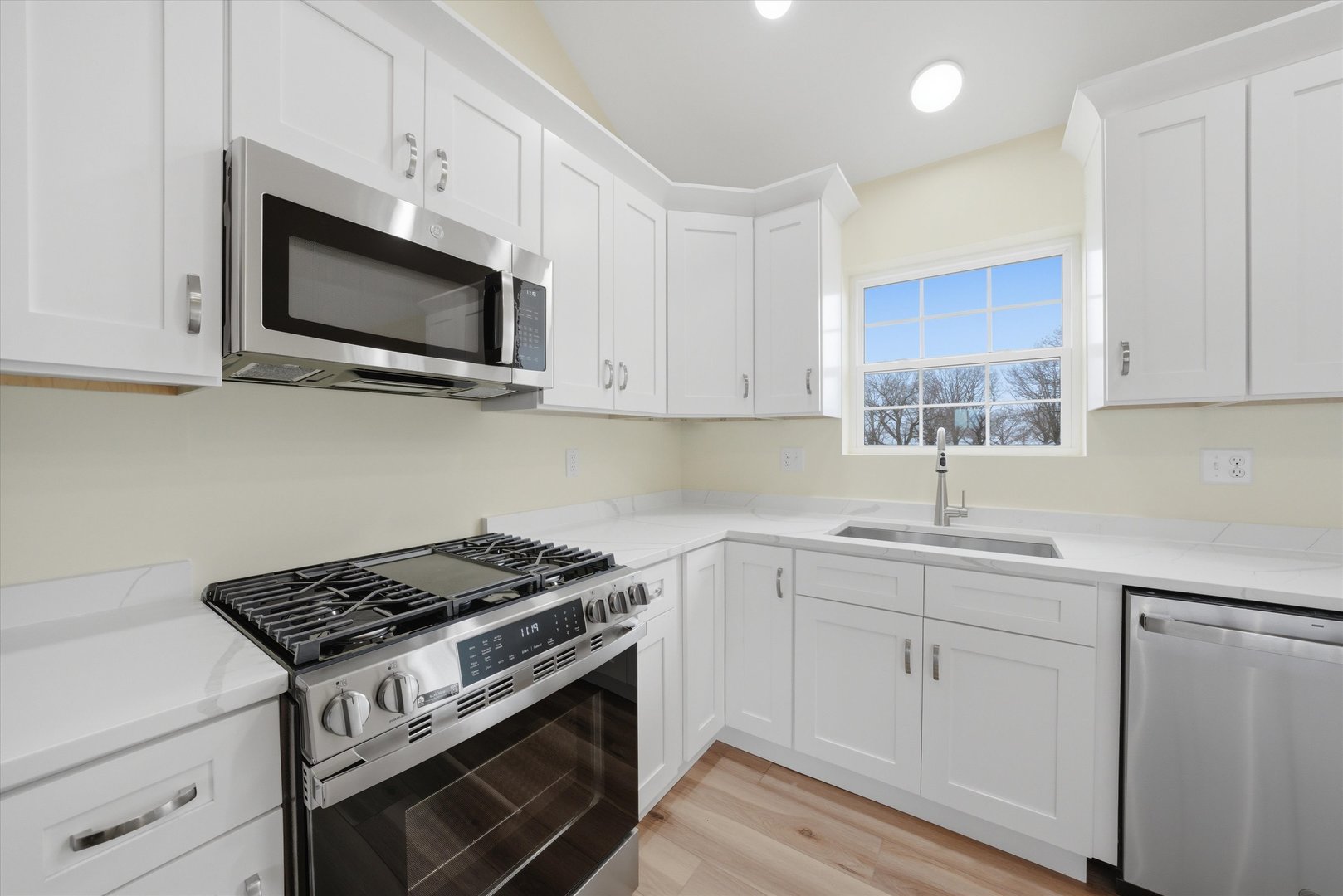477 Emma Drive Manteno, IL 60950 - Photo 8 of 29 a kitchen with white cabinets and stainless steel appliances