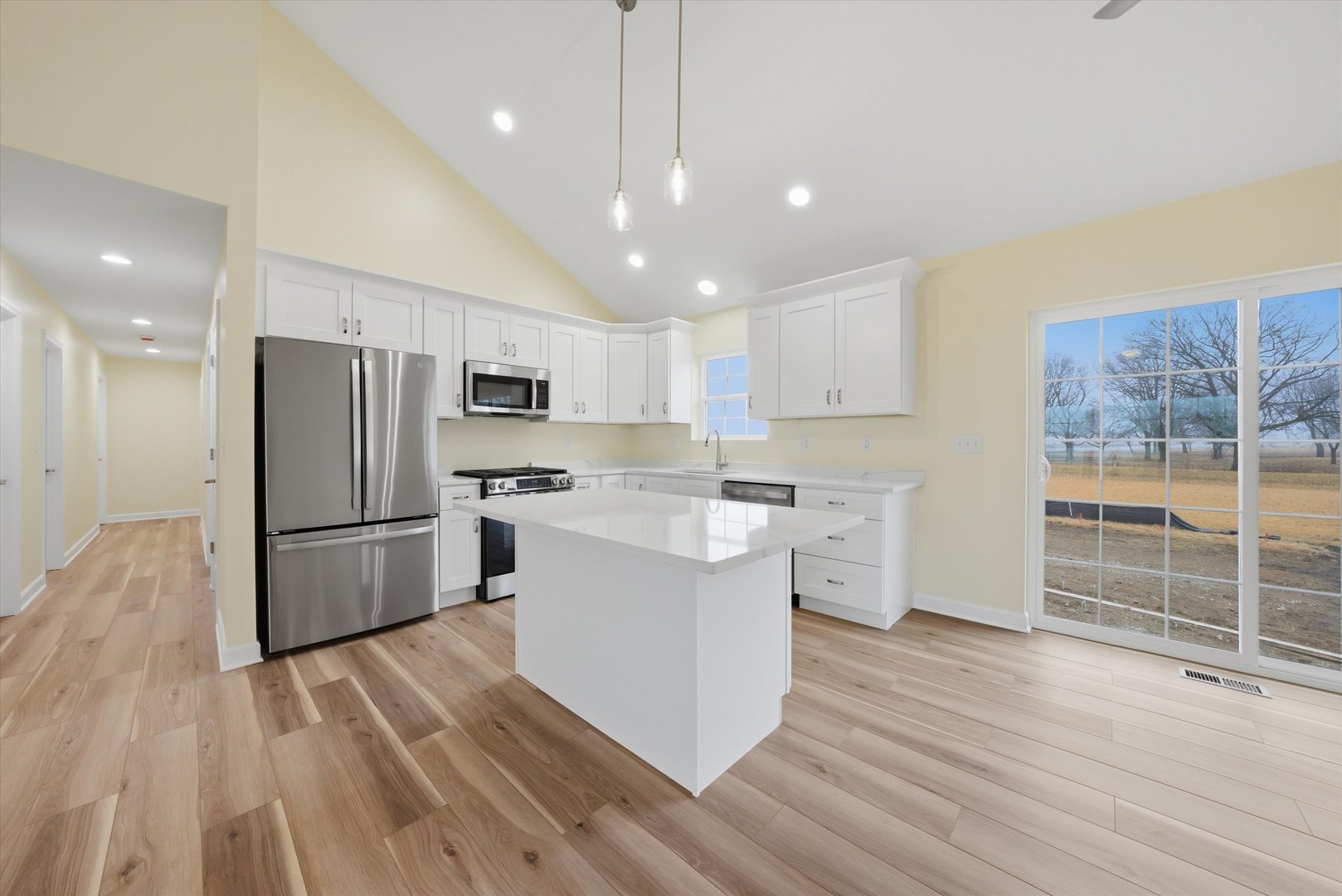 477 Emma Drive Manteno, IL 60950 - Photo 9 of 29 a kitchen with white cabinets and stainless steel appliances