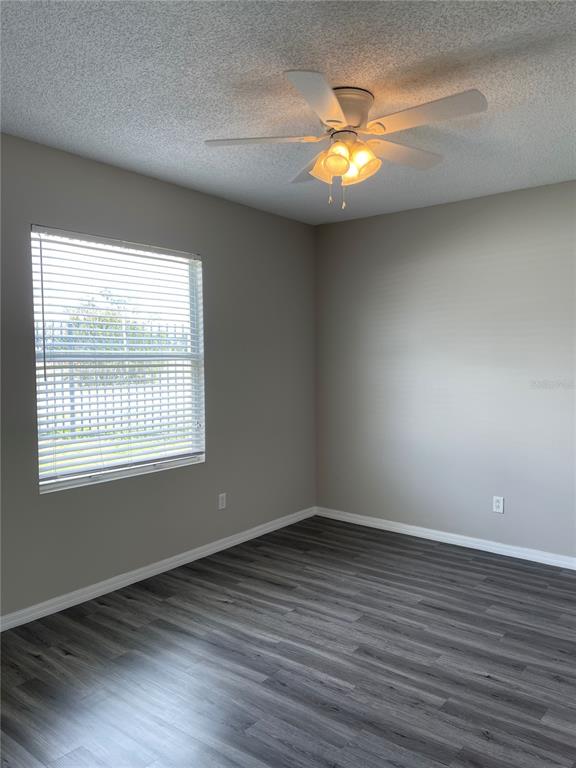 606 Sunset View Drive Davenport, FL 33837 - Photo 11 of 30 an empty room with wooden floor and windows