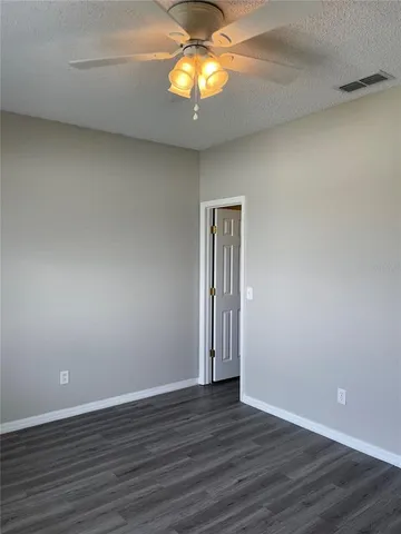 a view of a livingroom with wooden floor and chandelier