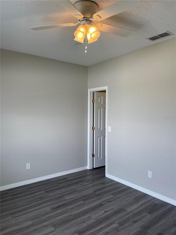 606 Sunset View Drive Davenport, FL 33837 - Photo 12 of 30 a view of a livingroom with wooden floor and chandelier