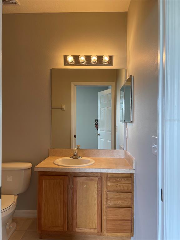 606 Sunset View Drive Davenport, FL 33837 - Photo 14 of 30 a bathroom with a sink and a toilet