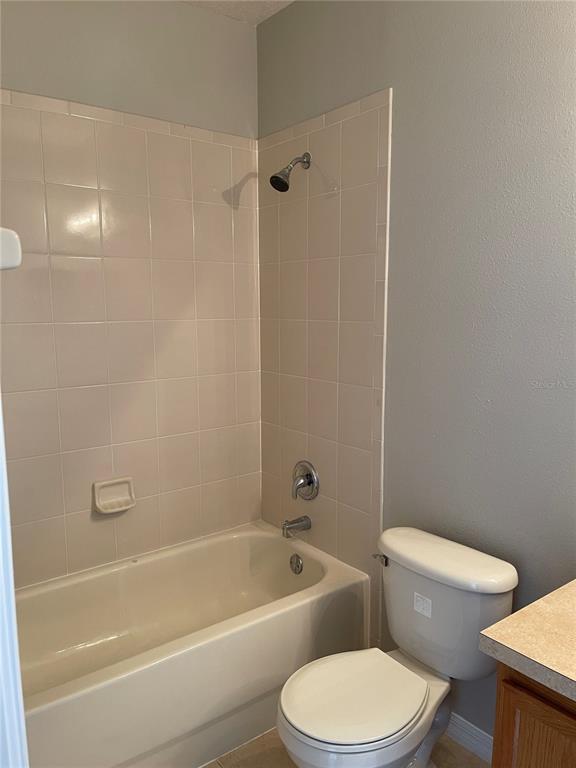606 Sunset View Drive Davenport, FL 33837 - Photo 15 of 30 a white toilet and tub sitting next to a bathroom sink