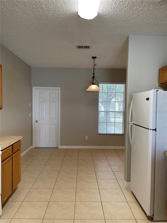 606 Sunset View Drive Davenport, FL 33837 - Photo 2 of 30 a view of a kitchen with a refrigerator and microwave