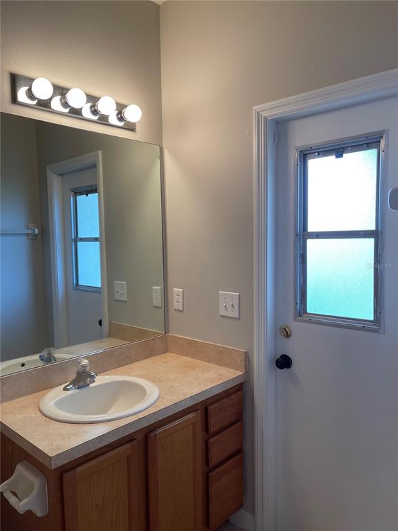 606 Sunset View Drive Davenport, FL 33837 - Photo 22 of 30 a bathroom with a sink and a mirror