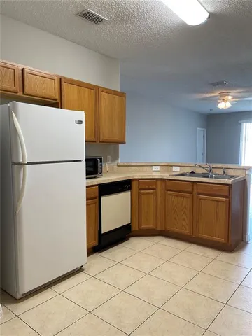 a kitchen with a stove top oven sink and cabinets