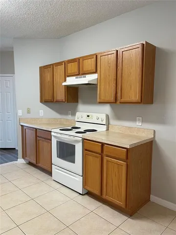 a kitchen with a sink and a stove top oven