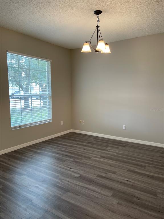 606 Sunset View Drive Davenport, FL 33837 - Photo 8 of 30 a view of an empty room with wooden floor and a window
